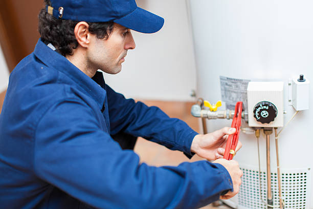 a plumber performing a water heater replacement.