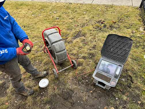 a plumber conducting a sewer camera inspection.