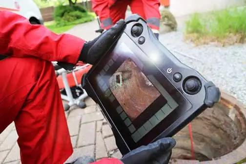 a plumber conducting a sewer camera inspection.